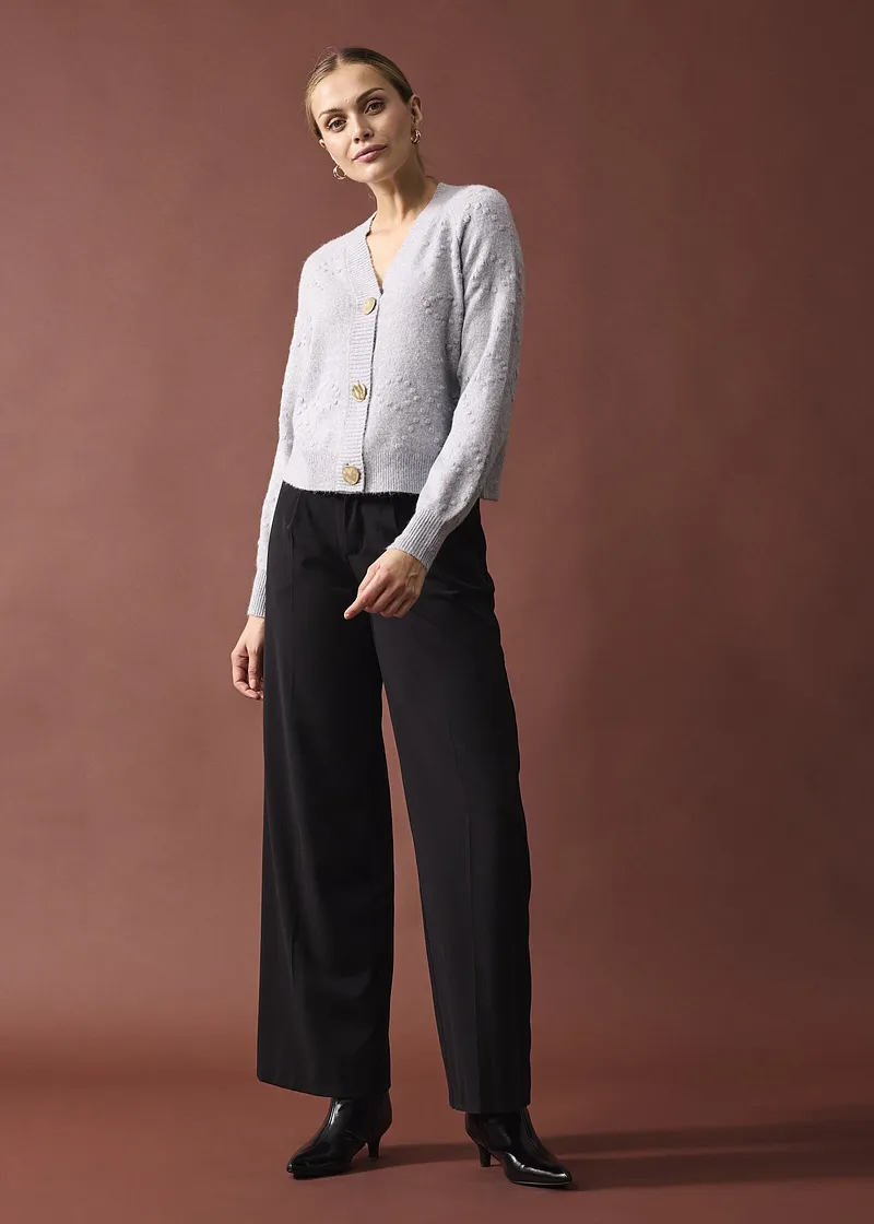 Elegant wit vest met grote knopen.