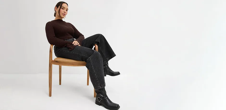 Longsleeve, zwarte jeans en imitatieleren laarzen.