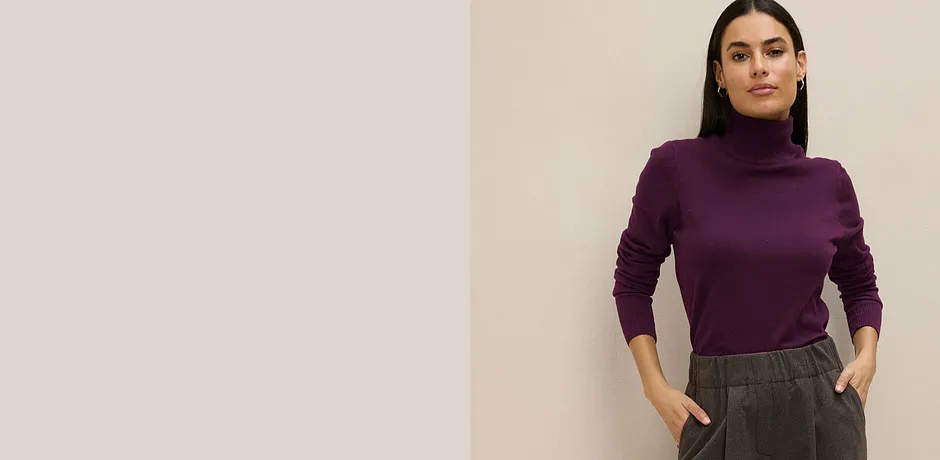 Lila coltrui gecombineerd met grijze broek.